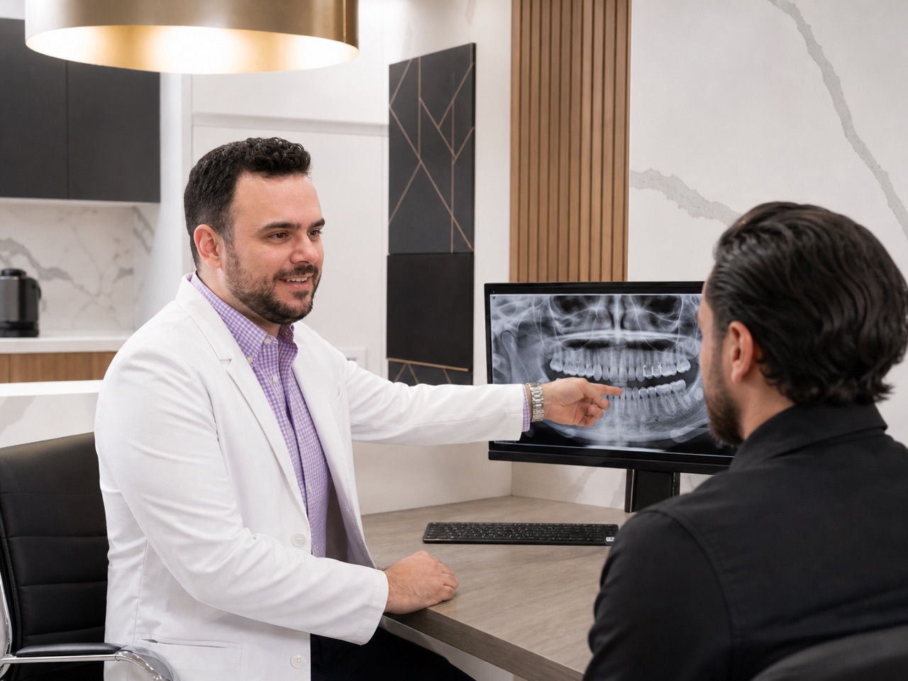 Dr. Daniel Avezoff discussing a digital X-ray with a patient