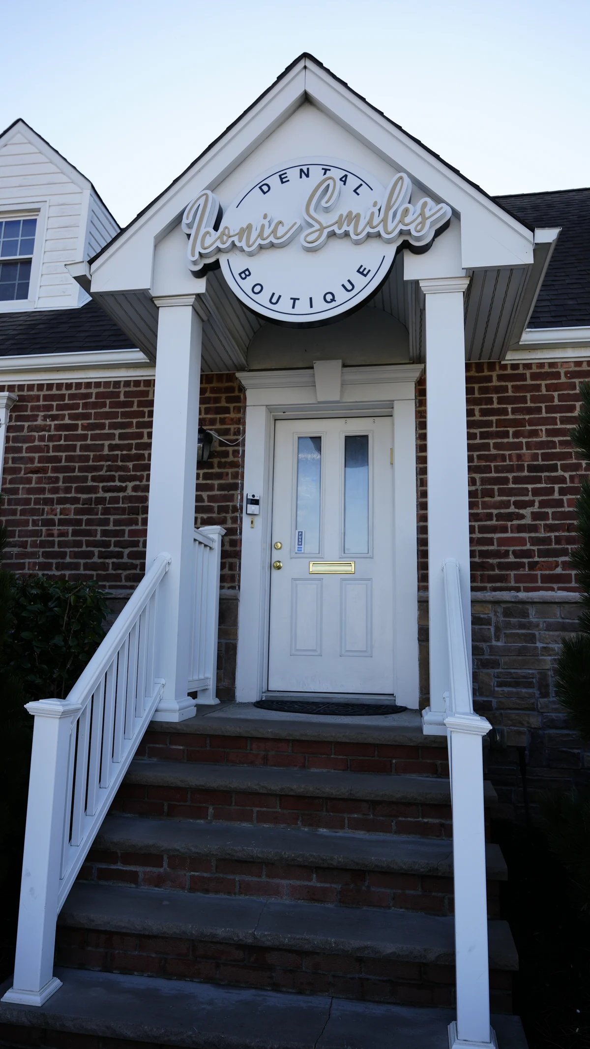 Front entrance and sign at Iconic Smiles Bellerose